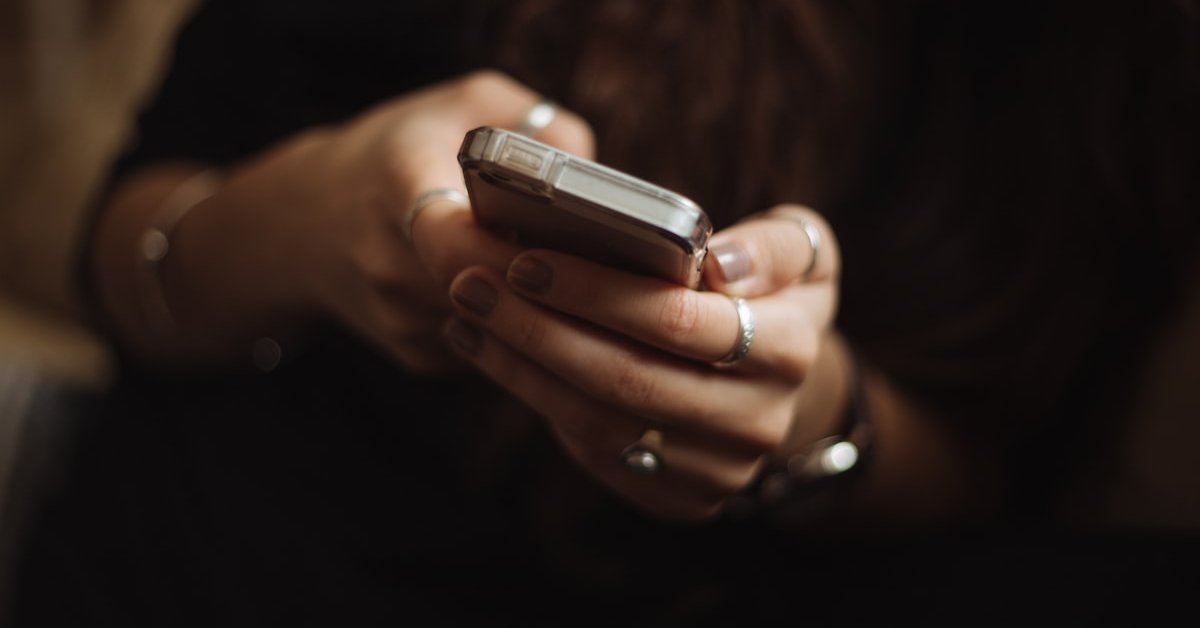 Close-up of hands holding and texting on a smartphone