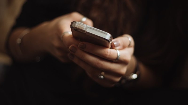 Close-up of hands holding and texting on a smartphone